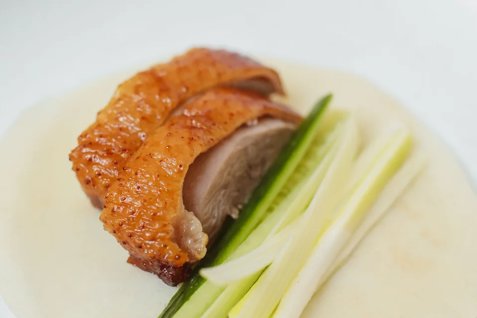 Example photo: Crispy Peking duck with cucumber and spring onions on a thin pancake