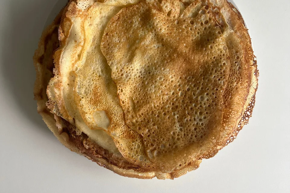 Example photo: Thin golden pancakes on a white plate